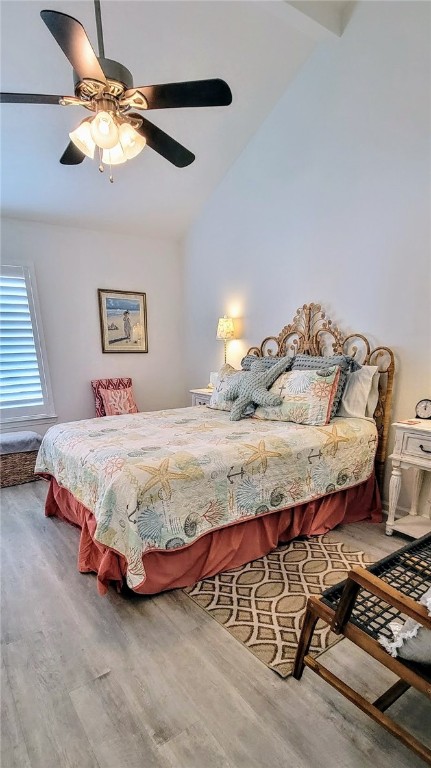 bedroom with vaulted ceiling, hardwood / wood-style flooring, and ceiling fan