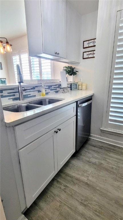 kitchen with dark wood-type flooring, dishwasher, decorative backsplash, white cabinets, and sink