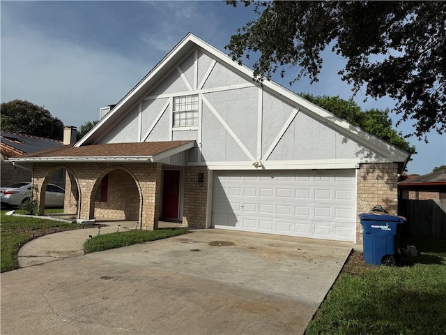11614 Coleta Creek Dr, Corpus Christi, TX 78410 - tudor house with concrete driveway, covered porch, brick siding, and a garage