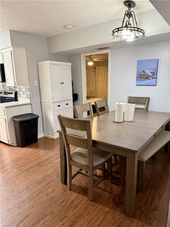 11614 Coleta Creek Dr, Corpus Christi, TX 78410 - dining room featuring wood finished floors and a chandelier