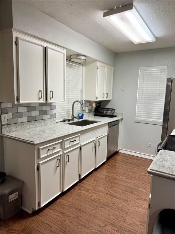 11614 Coleta Creek Dr, Corpus Christi, TX 78410 - kitchen with stainless steel appliances, backsplash, a textured ceiling, light countertops, and dark wood-type flooring