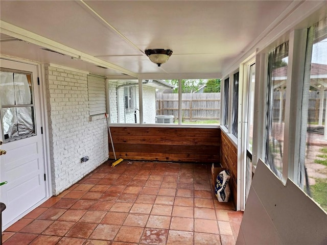 4725 Shea Pkwy, Corpus Christi, TX 78413 - unfurnished sunroom with brick wall, wood walls, and a wealth of natural light