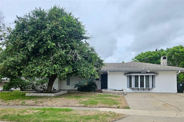 4725 Shea Pkwy, Corpus Christi, TX 78413 - view of front of house with a chimney, brick siding, and concrete driveway