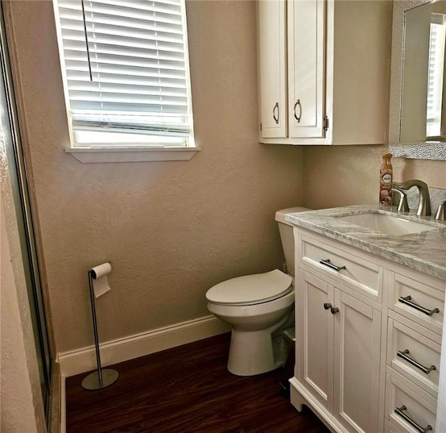 4725 Shea Pkwy, Corpus Christi, TX 78413 - bathroom featuring vanity, toilet, baseboards, and wood finished floors