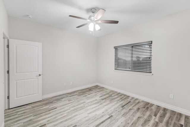 empty room featuring ceiling fan and light hardwood / wood-style floors