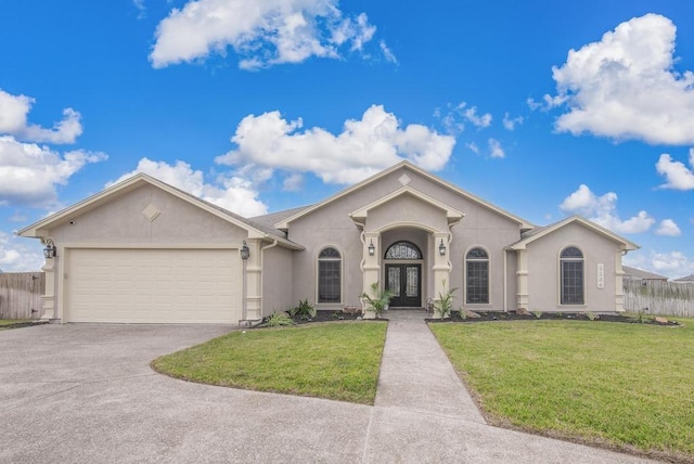 single story home featuring french doors, a garage, and a front lawn