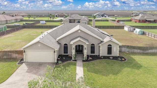 single story home featuring a front yard and a garage