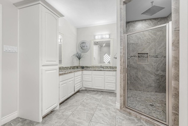 bathroom with a shower with door and vanity