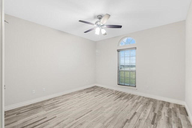 empty room featuring light wood-type flooring and ceiling fan