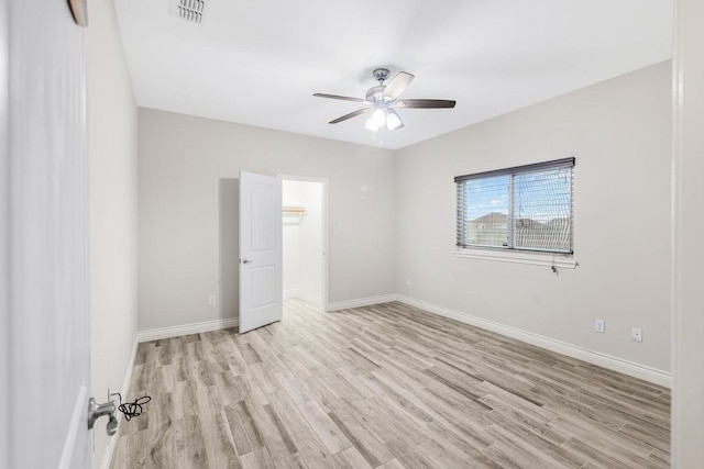 spare room featuring ceiling fan and light hardwood / wood-style flooring