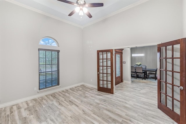 empty room featuring french doors, light hardwood / wood-style flooring, ceiling fan, and crown molding