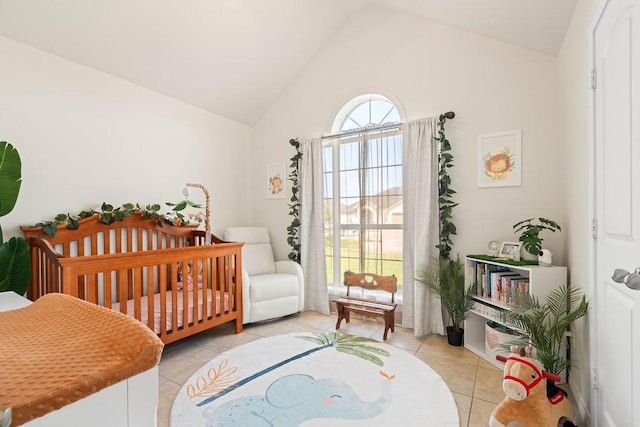 bedroom with light tile patterned floors and vaulted ceiling