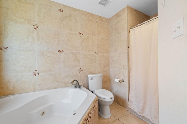 full bathroom featuring visible vents, toilet, a jetted tub, tile walls, and tile patterned floors