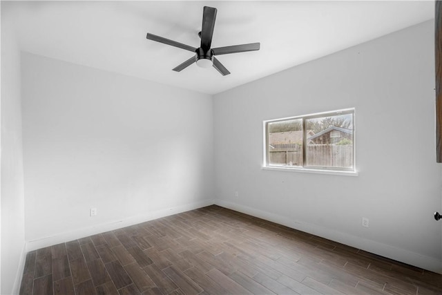 spare room with a ceiling fan, wood finished floors, and baseboards