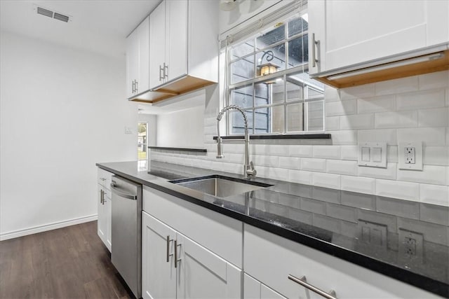 kitchen featuring decorative backsplash, dark hardwood / wood-style flooring, stainless steel dishwasher, sink, and white cabinetry