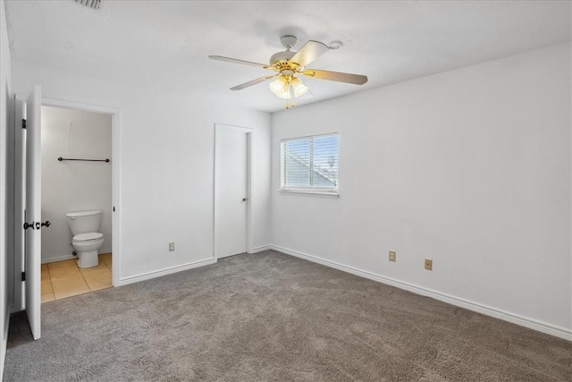 unfurnished bedroom with ceiling fan, ensuite bathroom, and light carpet