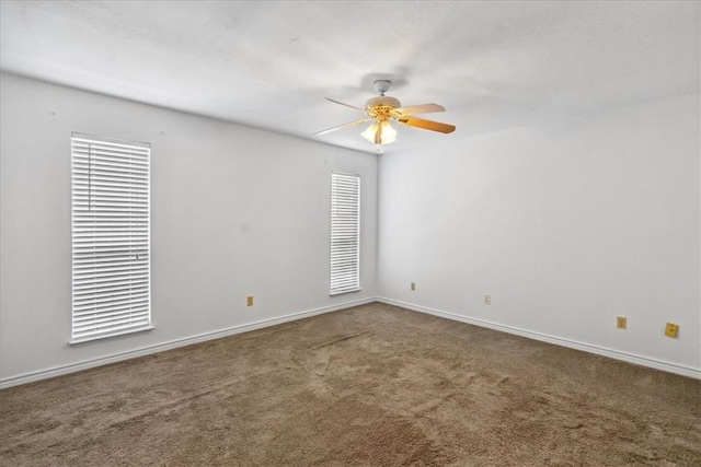 unfurnished room with ceiling fan and carpet