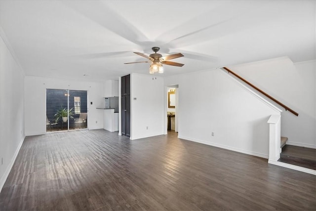 unfurnished living room with ceiling fan and dark hardwood / wood-style flooring