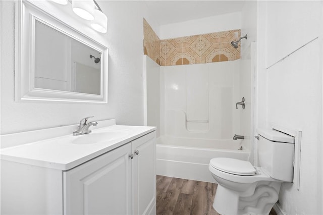 full bathroom featuring hardwood / wood-style floors, vanity,  shower combination, and toilet