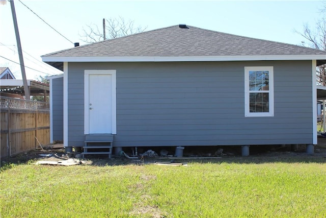 rear view of property featuring a lawn