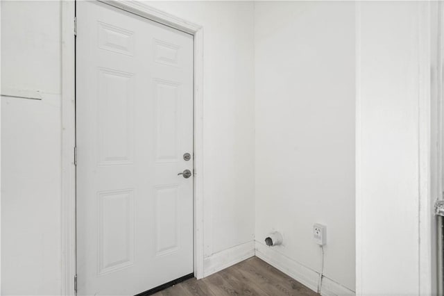 washroom featuring dark hardwood / wood-style flooring and electric dryer hookup