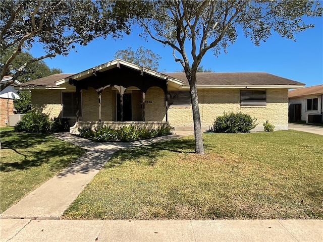 ranch-style house featuring central AC unit and a front yard