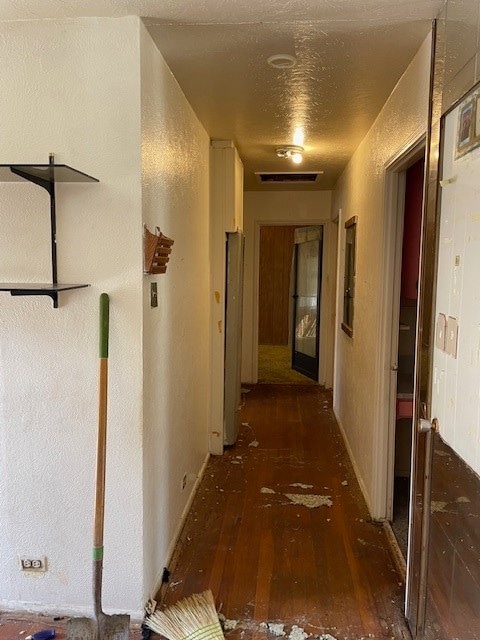 hallway with dark hardwood / wood-style flooring