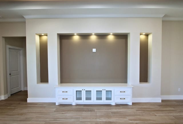 interior details featuring hardwood / wood-style floors and crown molding