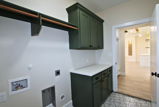 washroom featuring cabinets, hookup for a washing machine, light hardwood / wood-style flooring, and electric dryer hookup