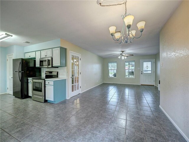 1305 S Whitney St, Aransas Pass, TX 78336 - kitchen featuring appliances with stainless steel finishes, baseboards, a chandelier, ceiling fan, and pendant lighting