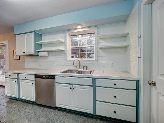 1305 S Whitney St, Aransas Pass, TX 78336 - kitchen with open shelves, stainless steel dishwasher, a sink, light countertops, and white cabinetry