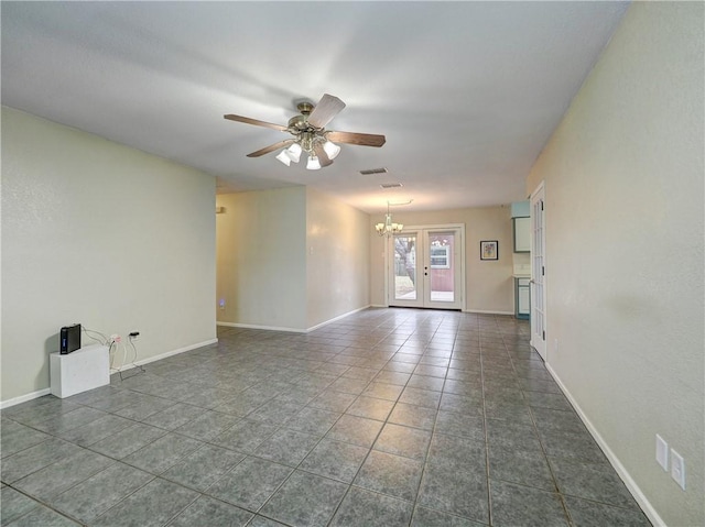 1305 S Whitney St, Aransas Pass, TX 78336 - empty room with a ceiling fan, a chandelier, dark tile patterned flooring, and baseboards