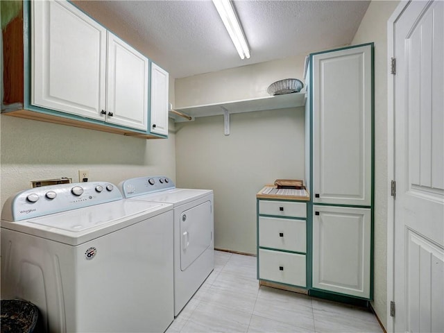 1305 S Whitney St, Aransas Pass, TX 78336 - washroom with washing machine and clothes dryer, cabinet space, a textured ceiling, and light tile patterned floors
