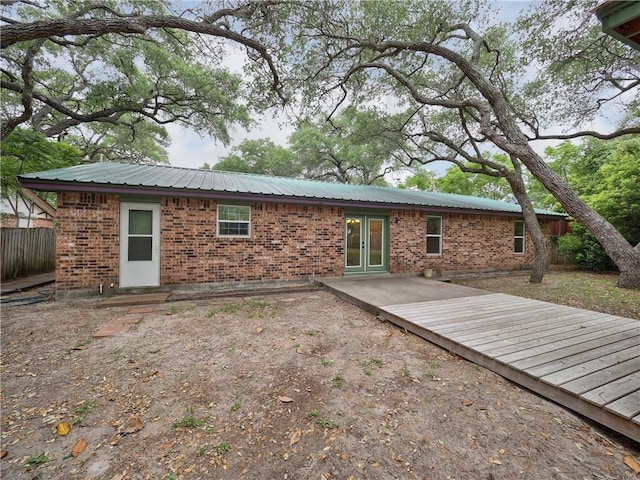 1305 S Whitney St, Aransas Pass, TX 78336 - rear view of house with french doors, brick siding, and metal roof
