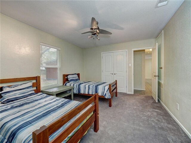 1305 S Whitney St, Aransas Pass, TX 78336 - carpeted bedroom with a closet, ceiling fan, baseboards, and a textured wall