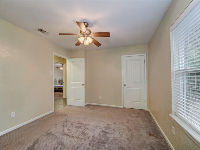 1305 S Whitney St, Aransas Pass, TX 78336 - unfurnished bedroom featuring carpet, a ceiling fan, and baseboards