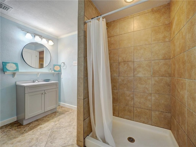 1305 S Whitney St, Aransas Pass, TX 78336 - bathroom featuring ornamental molding, baseboards, vanity, a shower stall, and tile patterned flooring
