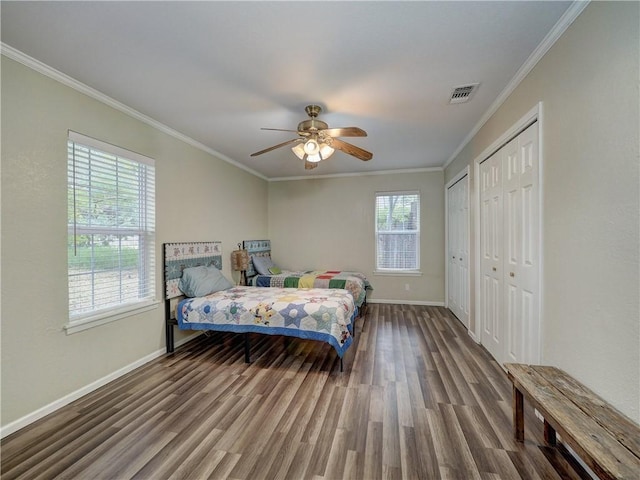 1305 S Whitney St, Aransas Pass, TX 78336 - bedroom with wood finished floors, baseboards, multiple closets, crown molding, and ceiling fan