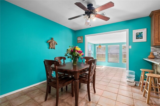 tiled dining room with ceiling fan