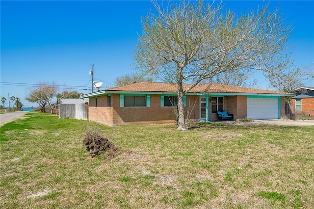 ranch-style house featuring a garage and a front lawn