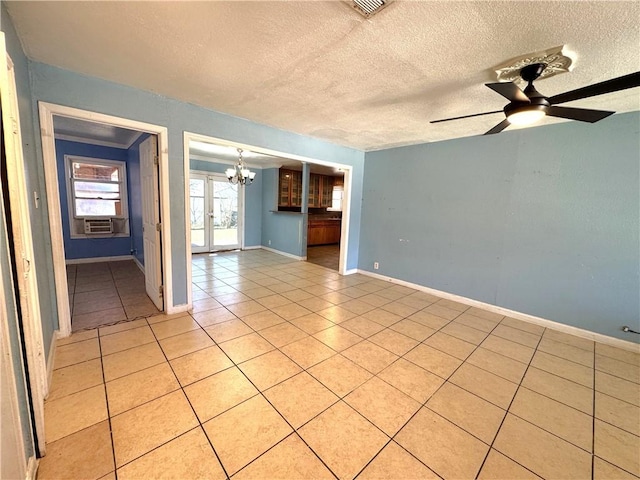 spare room with light tile patterned flooring, a textured ceiling, baseboards, and ceiling fan with notable chandelier