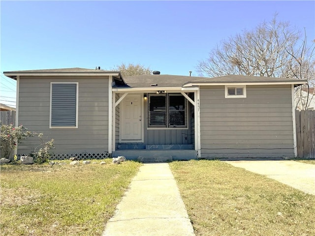 view of front of property featuring a front lawn, fence, and board and batten siding