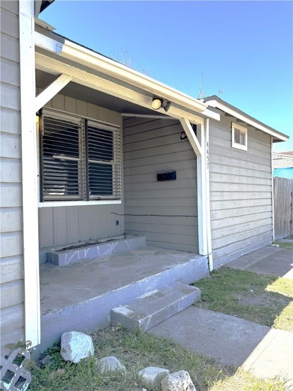 entrance to property featuring fence