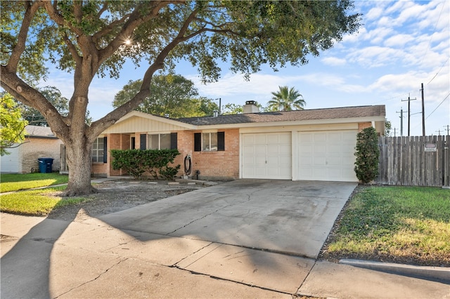 ranch-style house featuring a garage and a front lawn