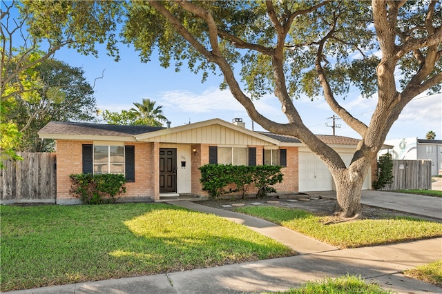 single story home featuring a front lawn and a garage