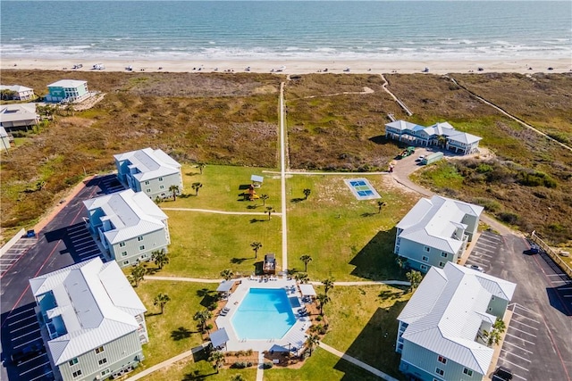 birds eye view of property with a beach view and a water view