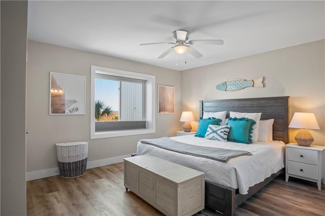 bedroom with wood finished floors, a ceiling fan, and baseboards