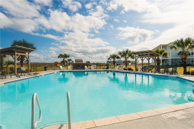 community pool featuring a patio area and fence