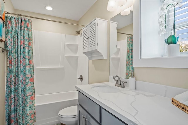 full bathroom featuring shower / bath combo, vanity, and toilet