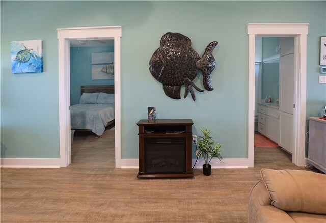 hallway with light hardwood / wood-style flooring